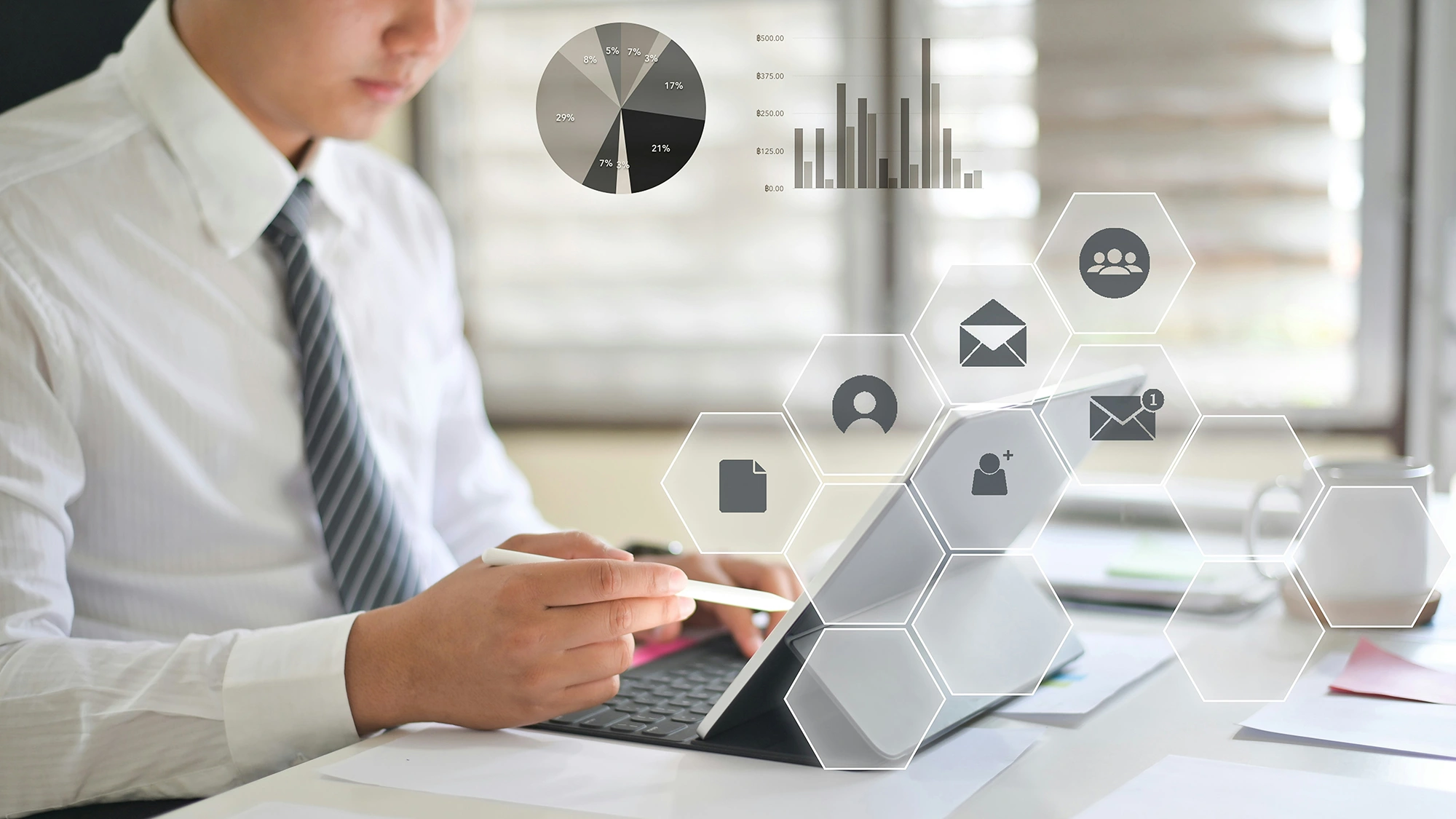 A businessman using a tablet with digital icons, representing end-to-end business process automation across workflows.