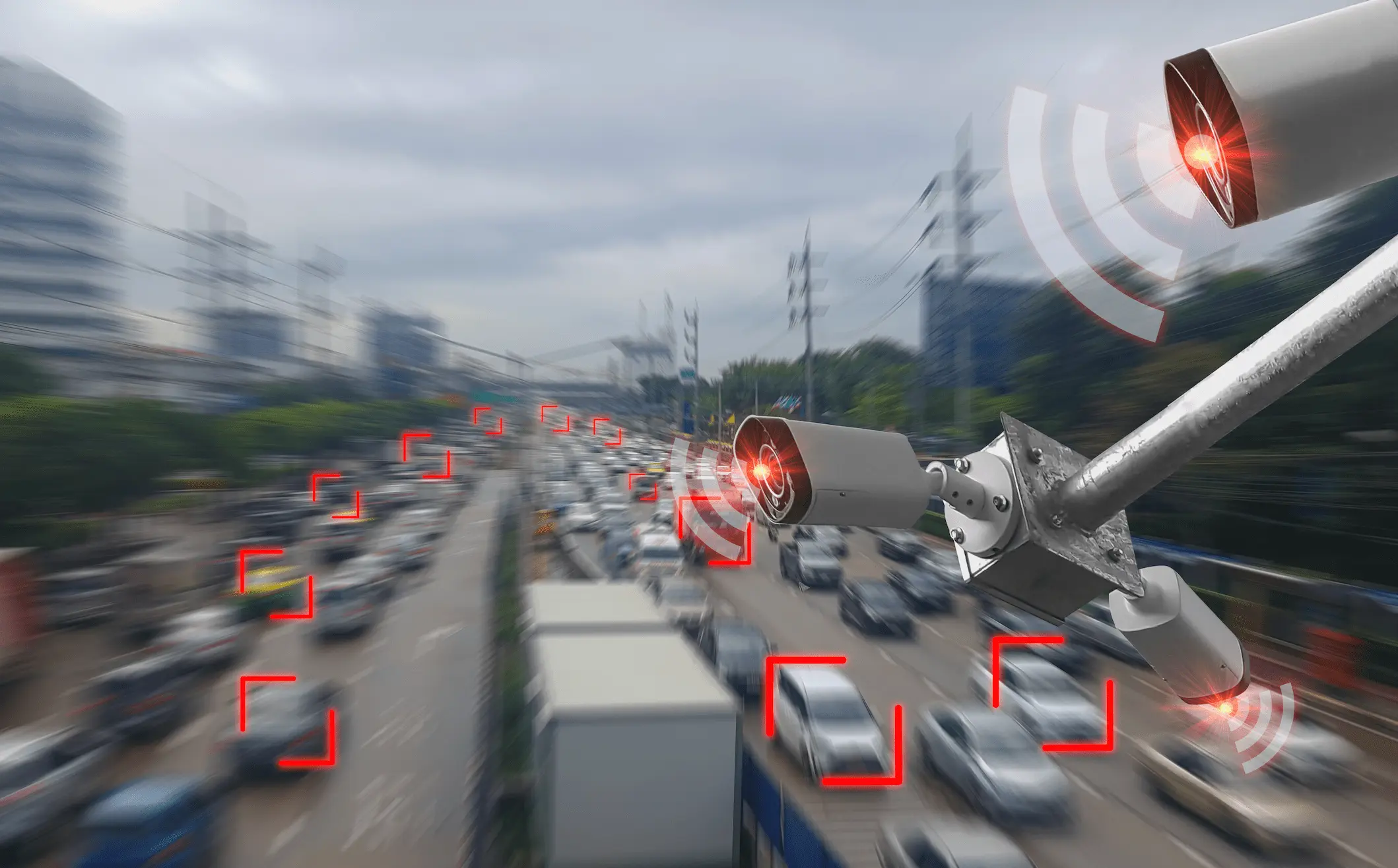 Surveillance cameras monitor moving vehicles on a congested city road.