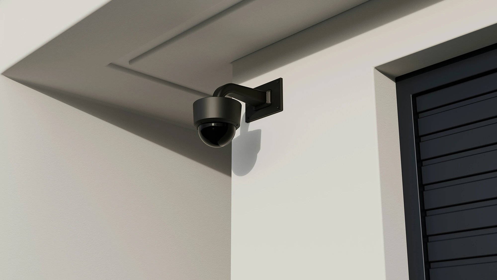 Black dome CCTV camera mounted on a building wall, part of a VsaaS system.
