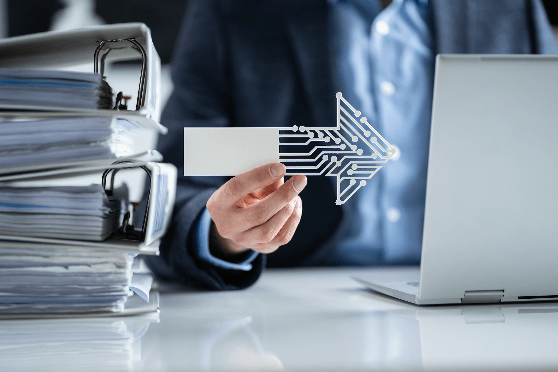 Person holding digital arrow icon illustrating shift from manual document processes to digitalisation.
